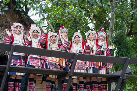 CHIANG MAI, THAILAND - AUGUST 26, 2023 : Akha women with traditional clothes and silver jewelry on wooden house in Akha tribe Villages. Young Asian lady Akha tribe.のeditorial素材