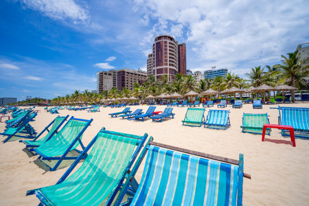 DANANG,  VIETNAM - AUGUST, 15 2023: Deck chairs in front of the My Khe beach on sunny day, It is a beautiful beach in Danang city , Vietnamのeditorial素材
