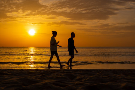 Danang, Vietnam - August 15, 2023 - Sunrise at My Khe beach, Danang, Vietnam. Vietnamese and tourists exercise along Da Nang beach at sunrise. silhouette many people walking seaside, relaxing, jogging on beachのeditorial素材