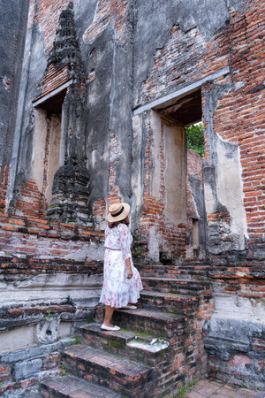 Travel Thailand tourist woman sightseeing Ayutthaya in Asia with old pagoda and spectacular Buddhist attraction in Wat Borom Phuttharam. Traveler in Historical Park of Thailandの写真素材