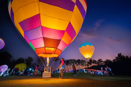 CHIANG MAI, THAILAND - December 15, 2023: Hot air balloons in the flower garden in evening twilight in Loy Krathong Festival 2024. Colorful Balloons in nightのeditorial素材
