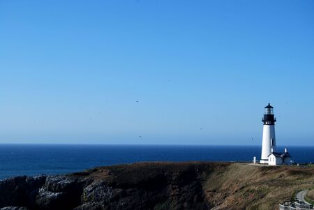 lighthouse securing the pacific ocean coastの写真素材