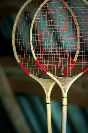 A couple of old badminton rackets hanging in the attic.の写真素材