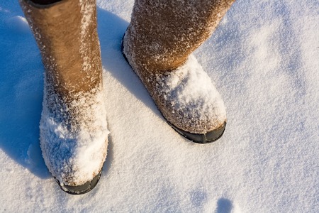 Winter shoes with a large size standing in the snow in the open air.  View from above.  Extreme...