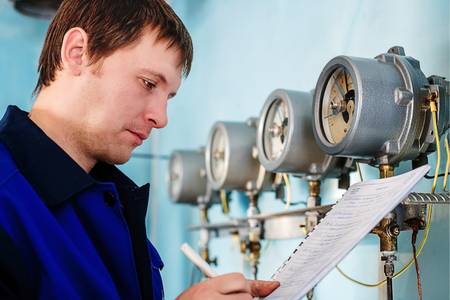 Engineer, worker registers readings of sensors and pressure gauges.の写真素材