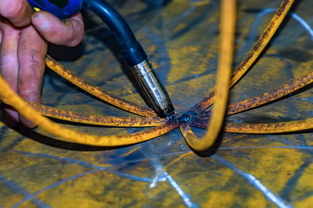 Welder cooks the product without gloves. Violation of safety regulations. Close-up