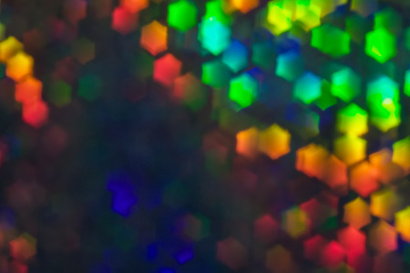 Bokeh, abstract colorful background of defocused hexagon stars. Festive lights and flicker