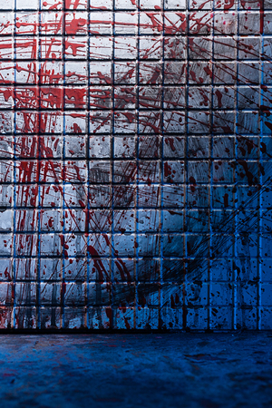 Cold and dark background from the scene of the murder. Dirty marble tile blurred by splashes of red blood. Room with a bloody wallの写真素材
