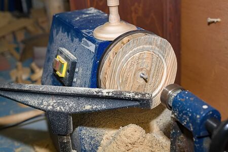 Lathe in the carpenter's shop close-up. Processing and production of wooden products on the equipment.の写真素材