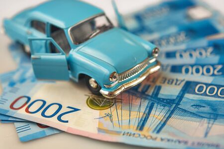 Toy retro car on a background of Russian money. The concept of collecting old cars.の写真素材