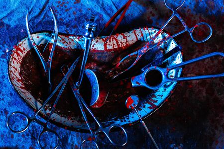 Dirty bloodstained medical utensils and tools on a gloomy table. The concept of illegal abortions at home. The old medical method of terminating pregnancyの写真素材
