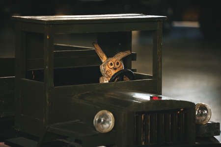 Alert and attentive driver behind the wheel of a wooden truck.