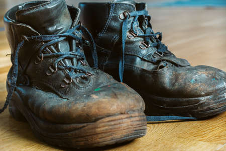 Old worn-out workmans shoes. Shoes that require repair or replacementの写真素材