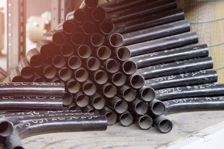 Black metal pipes and adapters of different diameters for gasification or water supply. Industrial...