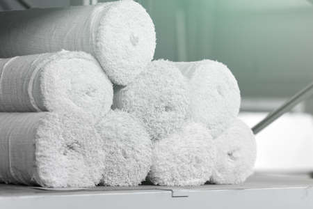 Rolls of factory textiles close-up. Raw material or material for making rags. Background with space to copyの写真素材