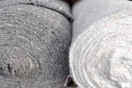 Rolls of factory textiles close-up. Raw material or material for making rags. Background with space to copyの写真素材
