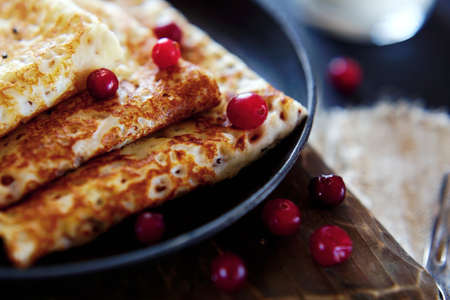 National Russian food. Pancakes in a frying pan with milk. Rustic stylization of a simple lunch.の写真素材