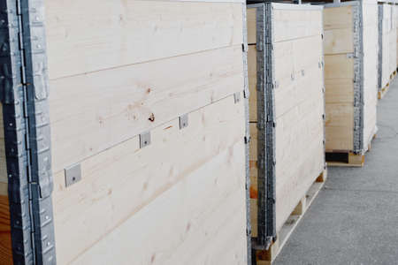 Wooden boxes made of planks are on the shelf of the warehouse. Packaging with copy space. Mockup