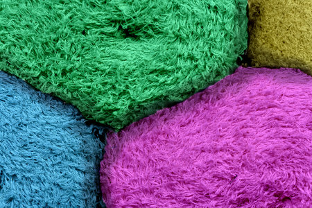 Colored tkan in rolls with a steep plan. Multi-colored rag with a long pile. Abstract background of manufactoryの写真素材