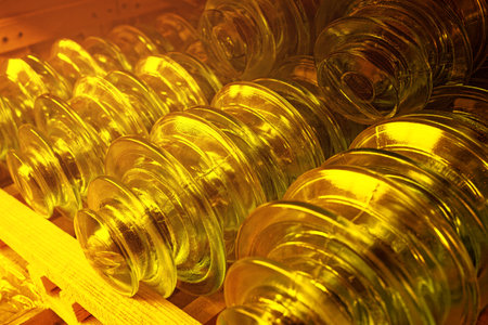 On the shelf are gold-colored glass insulators for high-voltage electric poles.