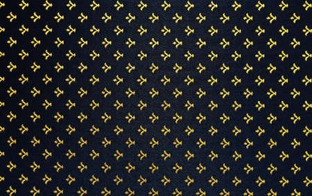 Elegant and rich abstract textile background. Gold monograms on the dark background.