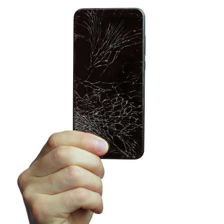 A mans hand holds a black phone with a broken screen. Isolated on a white background.の写真素材