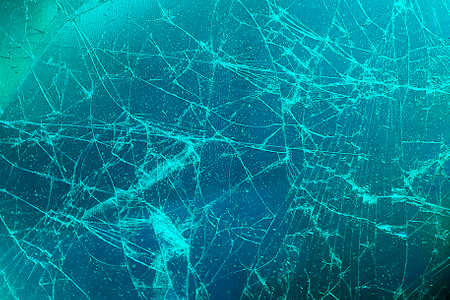 Broken glass display or cracked screen close-up. An empty, flat surface of a cold color.