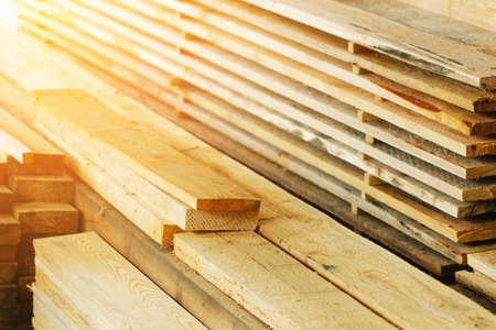 Boards and construction lumber lie in the carpentry workshop. woodworking. Background for the product supplier. Hardwoods.の写真素材