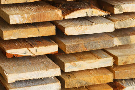 Boards and construction lumber lie in the carpentry workshop. woodworking. Background for the product supplier. Hardwoods.の写真素材