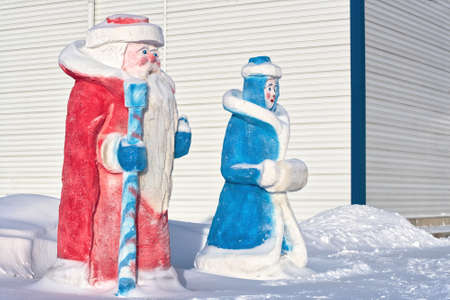 Christmas and new year figures made of snow: Santa Claus and snow maiden. High quality photoの写真素材
