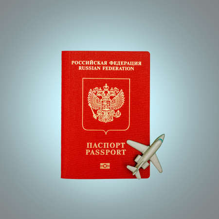 Toy plane and Russian passport. The concept of the beginning of the tourist season and the removal of restrictions on rest. Top viewの写真素材