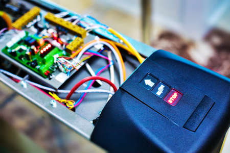 Setting up the turnstile for passing at the entrance. Device with wires and chips.background