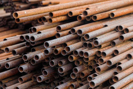 Many small-diameter metal pipes for gasification and construction lie in a stack in an open...