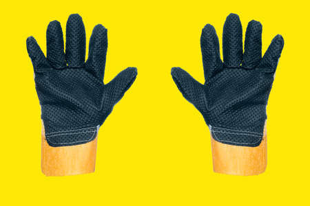Two construction gloves with splunk fingers. Protective clothing for work and construction. Advertising background.の写真素材