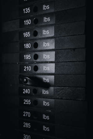 A cargo block on a sports simulator with numbers and weight. sports equipment close-up. Dark backgroundの写真素材