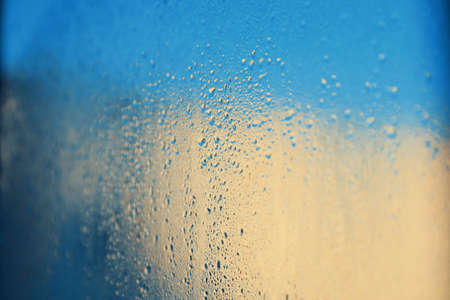 Abstract background. Drops on window glass. Color image.