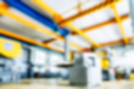 Empty production room in factory. Unfocused backdrop is industrial theme. Blurry background. Place...