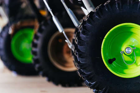 New tire with rubber tire. Detail of technique close-up. Copy space. Snow removal equipment or lawn mower. Agricultural Toolsの写真素材