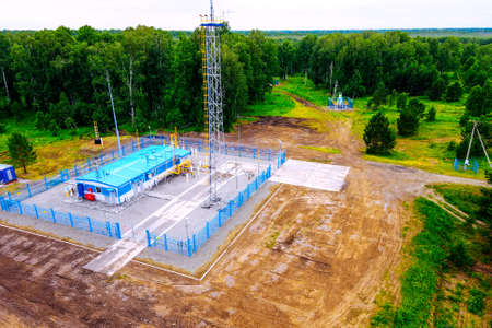 Natural gas distribution station of main gas pipeline. View from above. Type of gasification object on summer day. Construction of gas pipeline.の写真素材