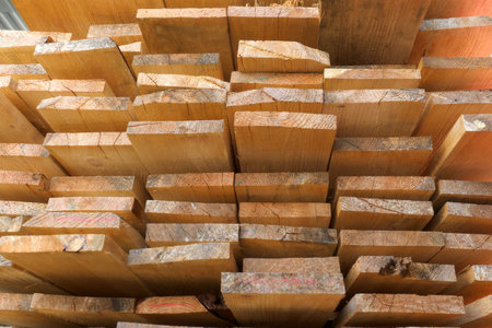 Wooden boards are stacked in a sawmill or carpentry shop. Sawing drying and marketing of wood....