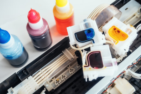 Filling inkjet printer with colored ink. Service for repair and maintenance of office equipment and equipment. Background. View from top..の写真素材