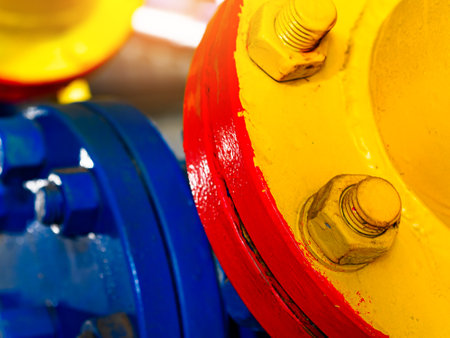 Close-up view of metal pipe connections. Industrial painting of metal parts. Wear-resistant all-weather paint. Abstract industrial background..の写真素材