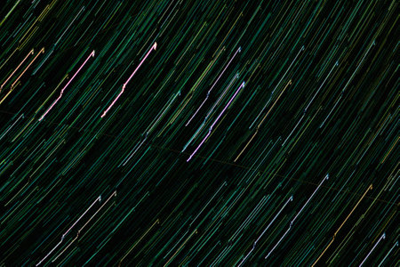 Traces of stars and planets in night sky. Luminous tracks of movement of celestial bodies. Abstract background..の写真素材