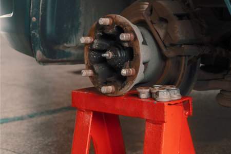 Repair of car brake discs. Hub and brake discs with pads in close-up analysis. Urgent repair in car service. Undercarriage detail. Background..の写真素材