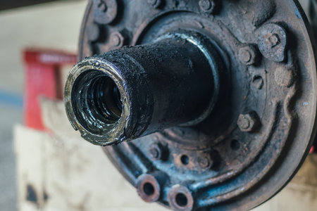 Repair of car brake discs. Hub and brake discs with pads in close-up analysis. Urgent repair in car service. Undercarriage detail. Background..の写真素材