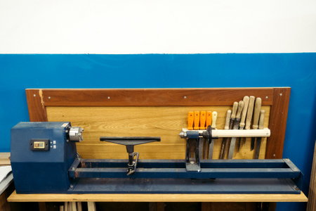 Wood lathe stands in carpentry shop. Background. Milling machine with tools for processing wooden products stands against wall. Copy space..の写真素材