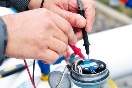 Checking gas equipment sensor with multimeter. Close-up hands. Diagnostics of industrial equipment.の写真素材