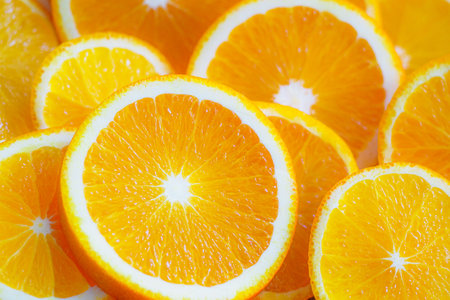 Round slices of fresh juicy oranges close-up. Bright fruity background for screensaver or backdrop in full screen.の写真素材