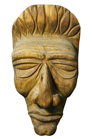 Mask of human face is carved out of wood. Antique religious totem of natives or people of ancient tribes. Symbol of idolatry. Isolated object on white background.の写真素材