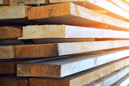 New planed wooden boards stacked in sawmill. Procurement and sale of building material. Dry wood. Woodworking. Background.の写真素材
